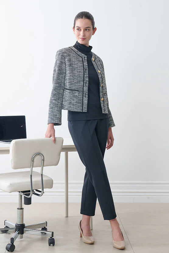 Woman in professional attire standing in an office setting