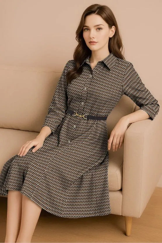 Seated model wearing a belted midi shirt dress.