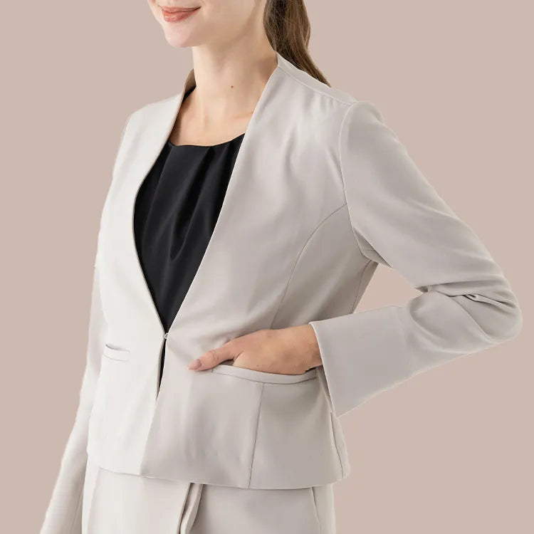 A refined collarless jacket with a minimal, sharp silhouette
