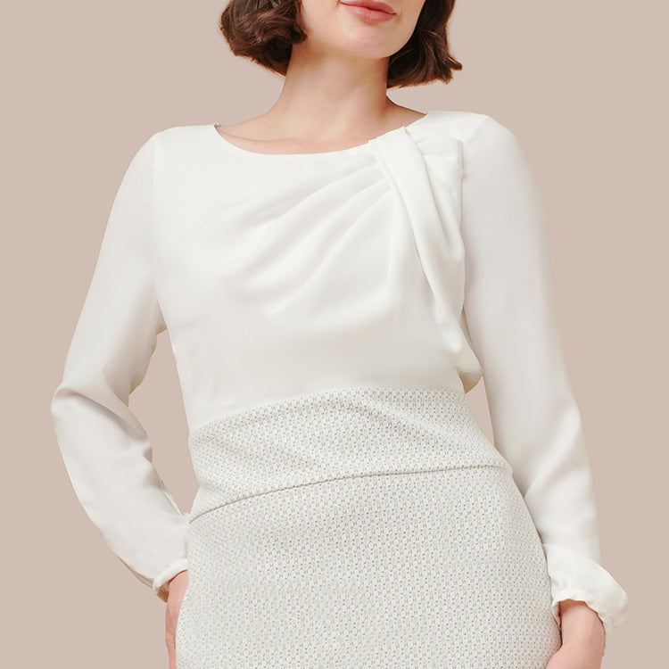 Elegant tucks draw the eye upwards.