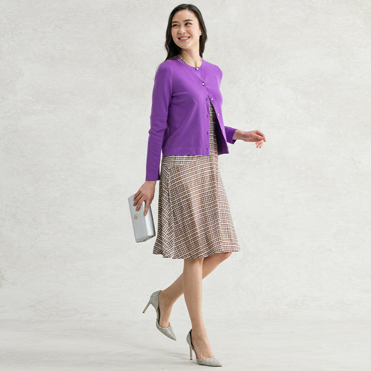 Match the accent color of the dress with a cardigan