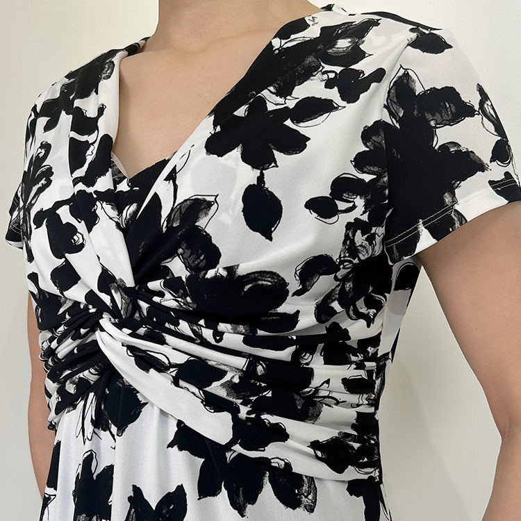 Artisan craftsmanship creates a beautifully twisted neckline.